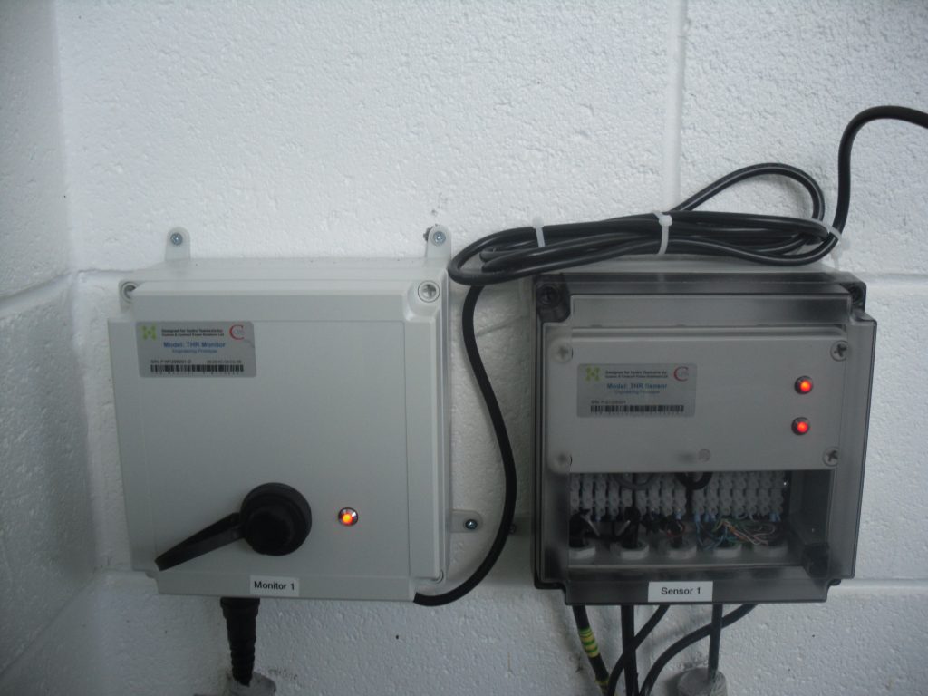 Two boxes side by side, left one containing the THR sensor, the right box containing the THR monitor. They look quite spiffy.